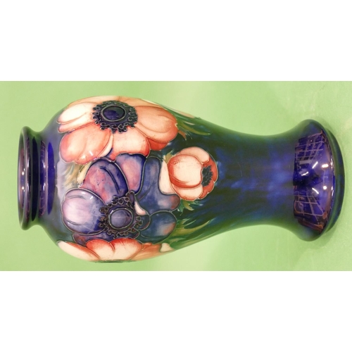 111 - A Moorcroft Round Bulbous Thin Necked Vase on blue ground with multicoloured, floral and leaf decora... 