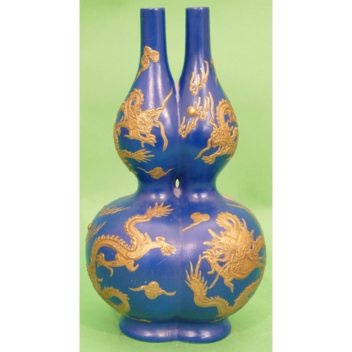 33 - An Oriental Bulbous Double Necked Vase on blue ground having raised gilt dragon decoration, 36cm hig... 