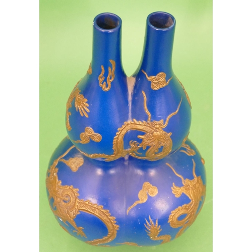 33 - An Oriental Bulbous Double Necked Vase on blue ground having raised gilt dragon decoration, 36cm hig... 