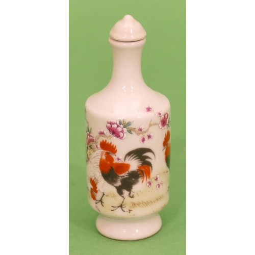 37 - An Oriental Round Bulbous Thin Necked Snuff Bottle with stopper on white ground with multicoloured b... 