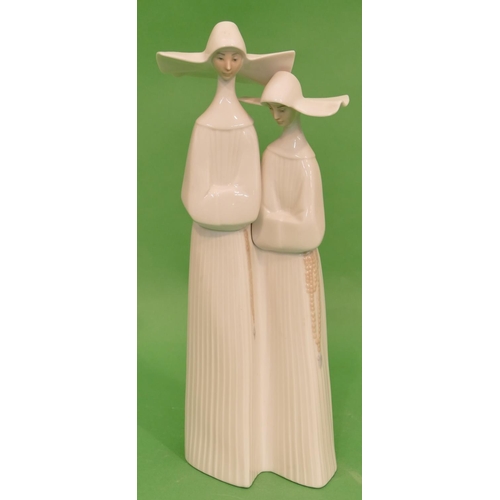 55 - A Lladro Group of 2 standing nuns, 33.5cm high.