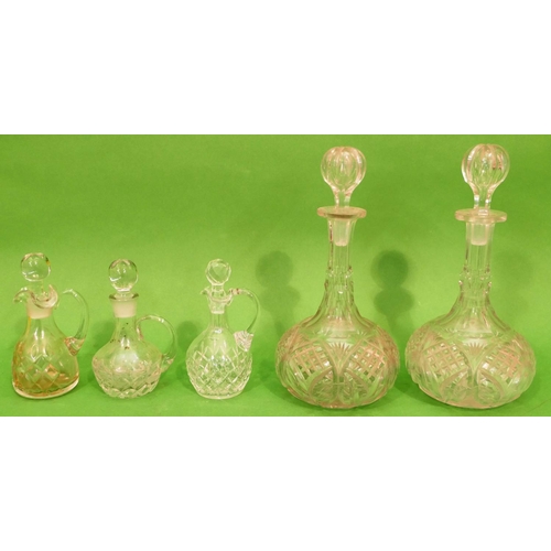 7 - A Pair of Glass Round Bulbous Thin Necked Decanters with stoppers, 30cm high, also 3 cut glass vineg... 