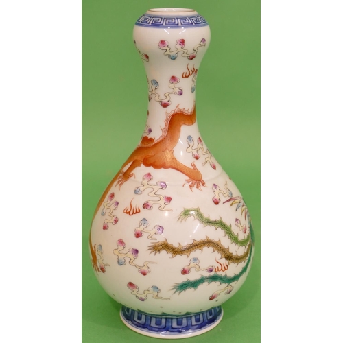 81 - An Oriental Bulbous Thin Necked Vase on white and blue ground with multicoloured, dragon and phoenix... 