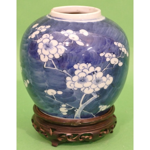 97 - A 19th Century Chinese Round Bulbous Ginger Jar on blue and white ground having blossom and branch d... 