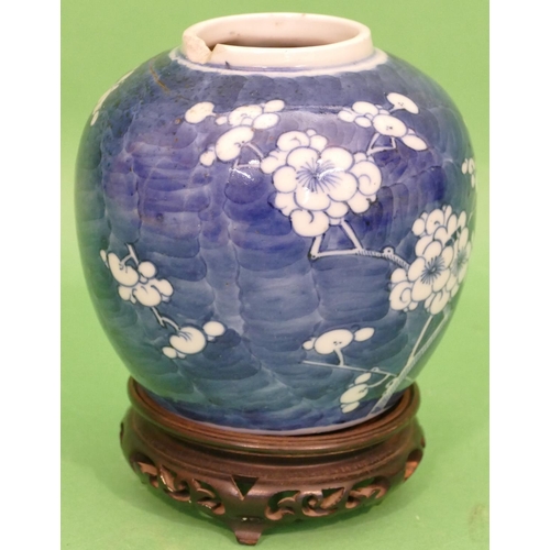 97 - A 19th Century Chinese Round Bulbous Ginger Jar on blue and white ground having blossom and branch d... 