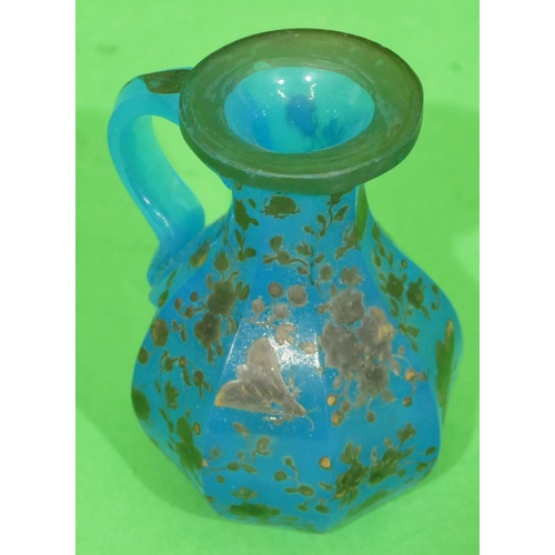 55 - A Blue Glass Octagonal Bulbous Thin Necked Bottle raised silvered decoration (no stopper) 11cm high.