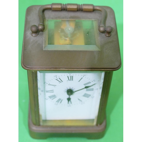 705 - A Brass Carriage Clock having white enamel dial with Roman and Arabic numerals (dial cracked) swing ... 