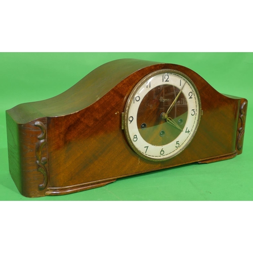 706 - An Urgos Mahogany 8 day Striking Westminster Chime Mantel Clock having arched top, Arabic numerals, ... 