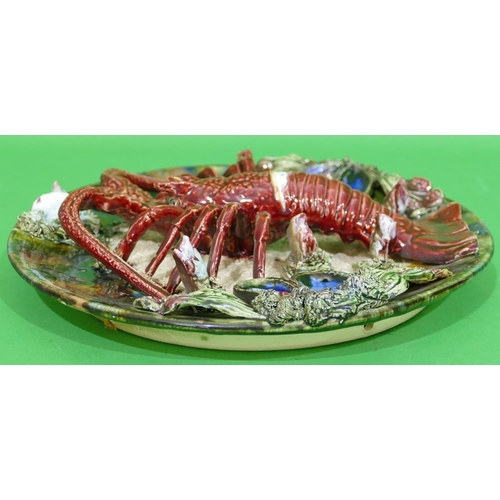 85 - A Palissy Style Majolica Plate encrusted with lobster, clams, shells etc, 32cm diameter.