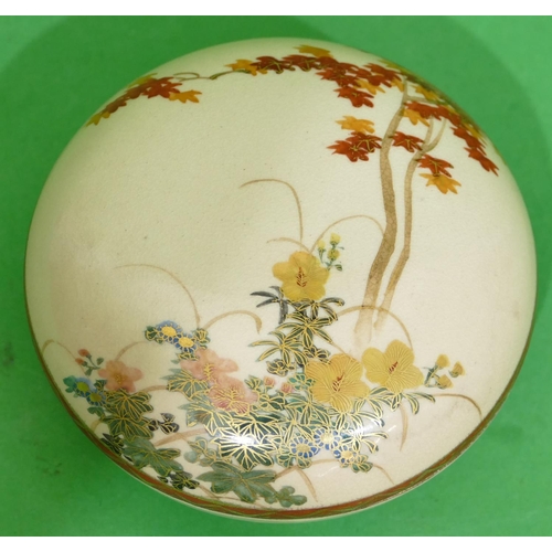 89 - An Oriental Satsuma Round Lidded Box on cream ground with multicoloured floral leaf and gilt decorat... 