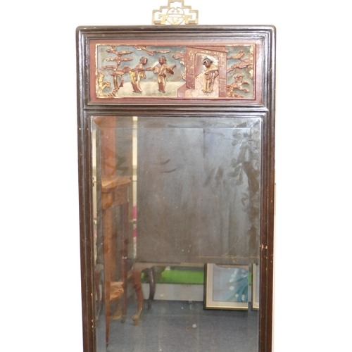 773 - An Oriental Hardwood Hanging Bevelled Wall Mirror with carved red and gilt figure motif, 1m 38.5cm h... 