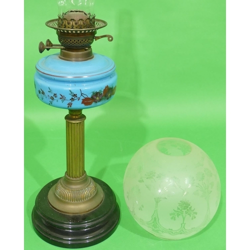 21 - A Gilt Metal and Blue Opaline Glass Oil Lamp having clear bulbous glass shade and chimney on round b... 