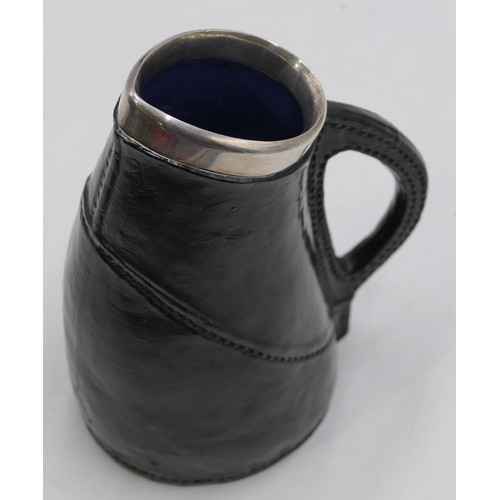 109 - A Royal Doulton silver rimmed black jug imitating a leather jack (marks rubbed) with Sterling silver... 