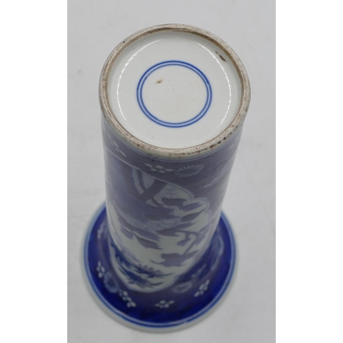 112 - An Oriental round cylindrical trumpet shaped vase on blue and white ground with floral and leaf deco... 