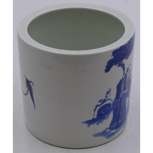 113 - An Oriental cylindrical brush pot on white and blue ground with figure decoration, 13cm high.