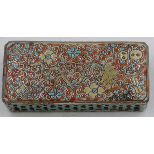 114 - An Oriental rectangular shaped scroll weight with pierced and coloured dragon, floral and scroll dec... 