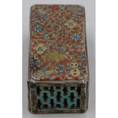 114 - An Oriental rectangular shaped scroll weight with pierced and coloured dragon, floral and scroll dec... 