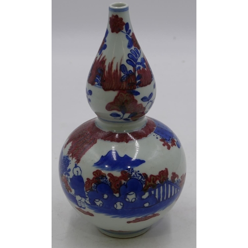 115 - An Oriental gould shaped vase on white, blue and red ground with children playing in garden, 23cm hi... 