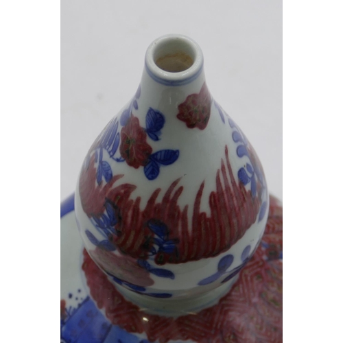 115 - An Oriental gould shaped vase on white, blue and red ground with children playing in garden, 23cm hi... 