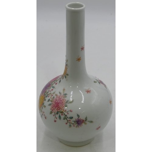 118 - An Oriental round bulbous thin necked vase on white ground with multi-coloured blossom and leaf deco... 