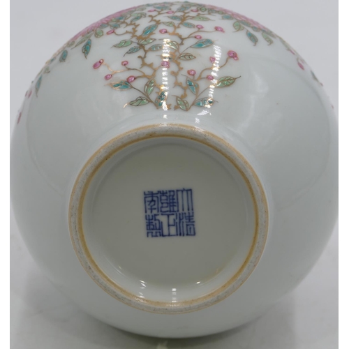 118 - An Oriental round bulbous thin necked vase on white ground with multi-coloured blossom and leaf deco... 