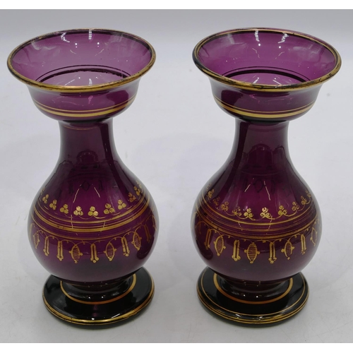 123 - A pair of Victorian purple glass round bulbous thin necked trumpet shaped vases with gilt decoration... 