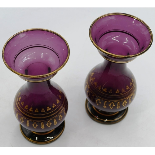 123 - A pair of Victorian purple glass round bulbous thin necked trumpet shaped vases with gilt decoration... 