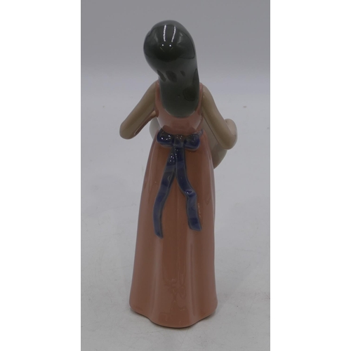 132 - A Lladro figure of a young girl in pink dress holding a bonnet, 25cm high.