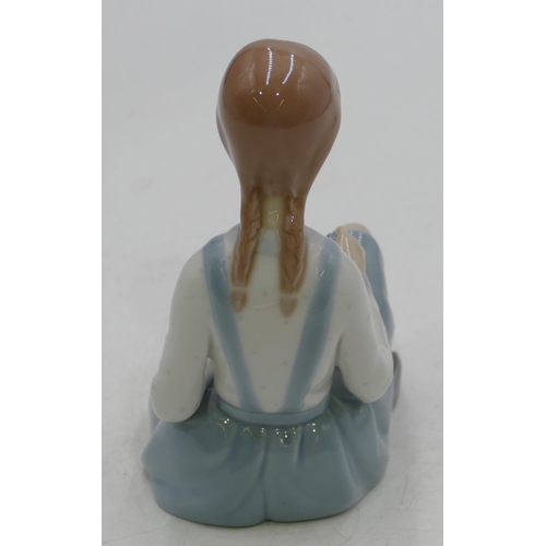 133 - A Lladro figure of a seated young girl (flowers missing), 16cm high.