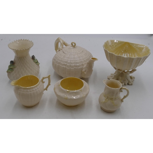 139 - A Belleek shell shaped round bulbous teapot, a similar jug, a Belleek milk jug and sugar bowl, a Bel... 