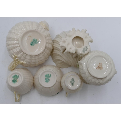 139 - A Belleek shell shaped round bulbous teapot, a similar jug, a Belleek milk jug and sugar bowl, a Bel... 