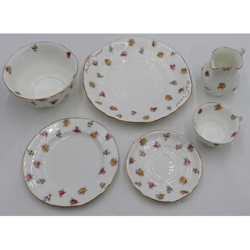 146 - W.A.A & Co tea service on white ground with multicolour floral and leaf decoration comprising a pair... 