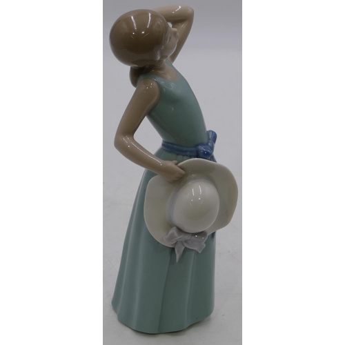 155 - A Lladro figure of a young girl holding a flower and bonnet, 24cm high