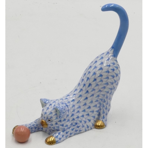 21 - A Herend blue and white china figure of a cat playing with a ball, 13cm high.