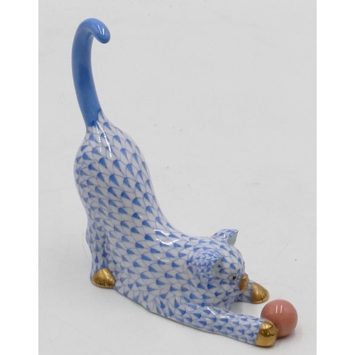 21 - A Herend blue and white china figure of a cat playing with a ball, 13cm high.