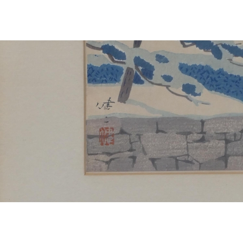 210 - An Oriental coloured woodblock print depicting building in snowy landscape, signed, framed, 36.5 x 2... 