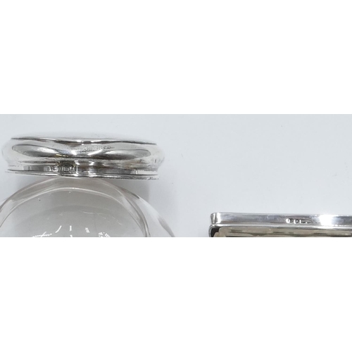 231 - A plain glass round bulbous dressing table bottle with London silver top, a rectangular cut glass dr... 