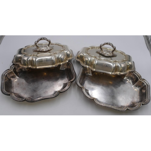 242 - A pair of silver plated rectangular scallop shaped entree dishes with covers, 31cm wide.