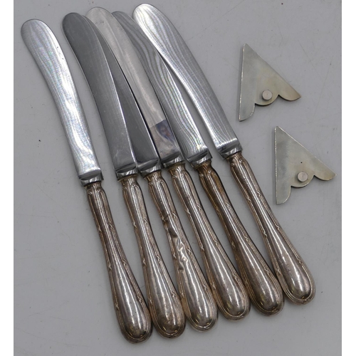 245 - A set of 6 silver handled butter knives and a pair of silver shirt collar mounts. (8)