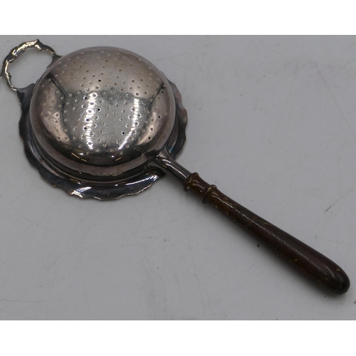 247 - A Birmingham silver round tea strainer with turned wooden handle.