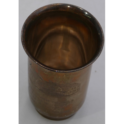 254 - An 830 silver gilt coloured metal round trumpet shaped beaker with engraved building and inscription... 