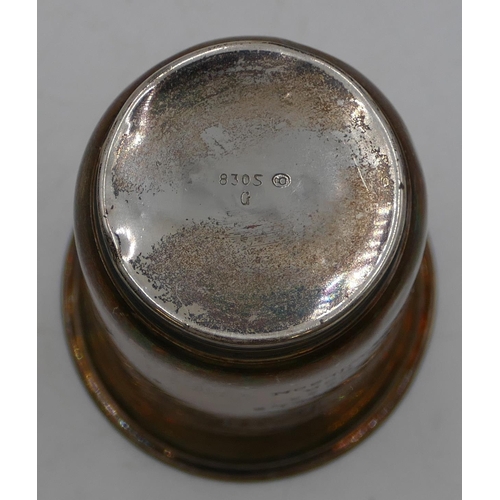 254 - An 830 silver gilt coloured metal round trumpet shaped beaker with engraved building and inscription... 