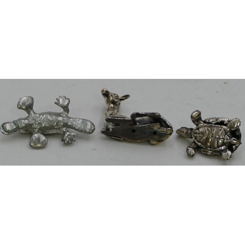 255 - A miniature 800 silver coloured metal model of a deer, 3cm high and 2 other metal figures of animals... 