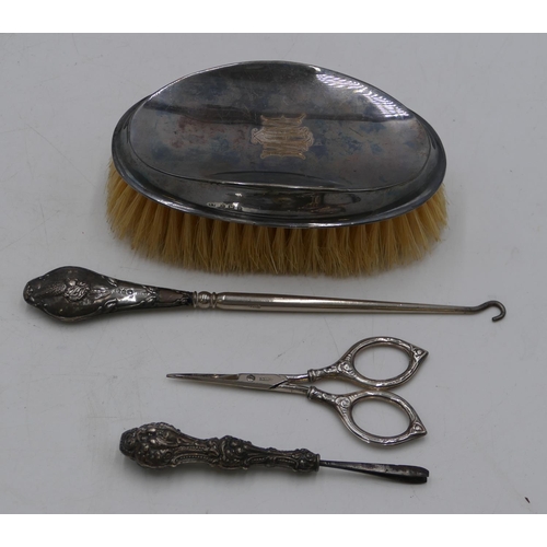 258 - A Birmingham oval gentleman's hairbrush, a pair of silver handled small scissors and 2 silver handle... 