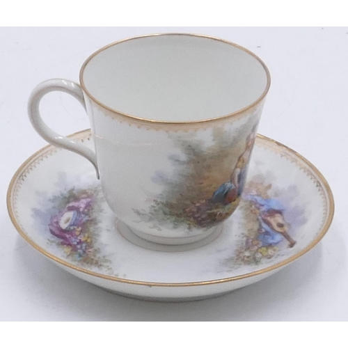 26 - A Serves cup and saucer on white ground with multi-coloured figure, musical instrument and landscape... 