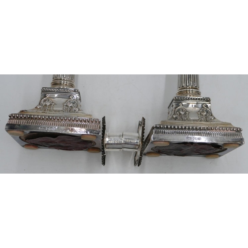 279 - A pair of Victorian silver Corinthian column candlesticks with embossed square sweeping bases, Sheff... 