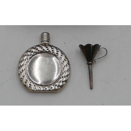 299 - A Sterling silver miniature flat scent bottle with screw lid and small funnel, cased