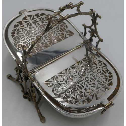 301 - A silver plated folding breakfast dish with hinged double sides, on branch shaped supports and splay... 