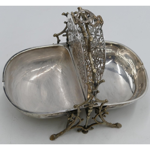 301 - A silver plated folding breakfast dish with hinged double sides, on branch shaped supports and splay... 