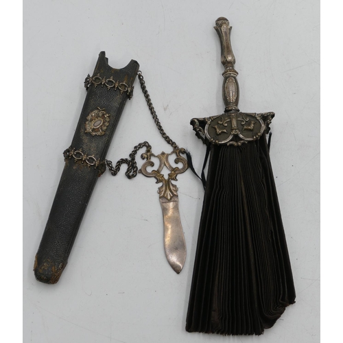 305 - A silver plated collapsible fan in form of a dagger, with leather sheath, embossed decoration, a set... 